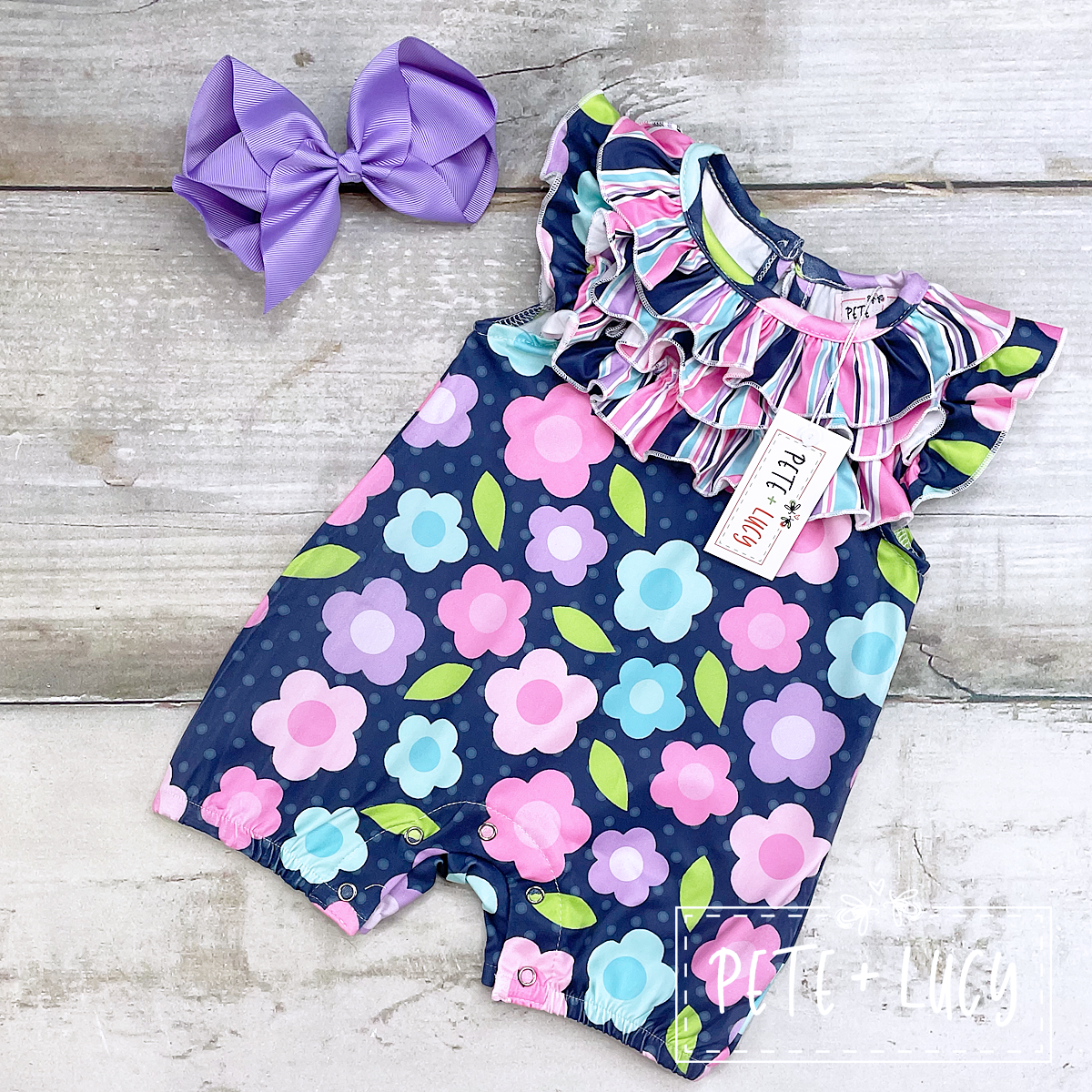 Navy Blue Romper with Flowers and striped ruffles